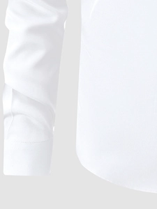 Close-up of cuff details and curved hem craftsmanship on a white business shirt