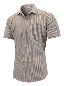 Detail of men's short-sleeve plaid shirt showing brown check fabric and chest pocket