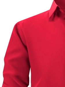 Detail view of red long sleeve shirt featuring a classic pointed collar and neat stitching