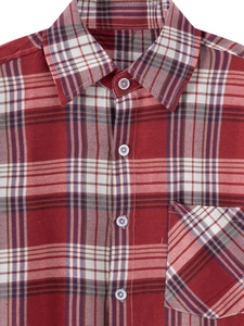 Detail of red plaid shirt showing the spread collar, white buttons and chest pocket
