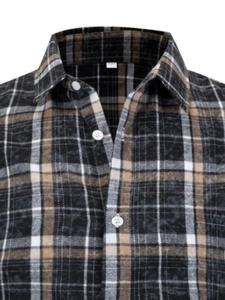 Close-up of classic brown plaid flannel shirt collar with white buttons and soft texture