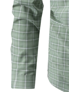 Close-up of green plaid shirt fabric texture showing fine weave and sleeve cuff detail