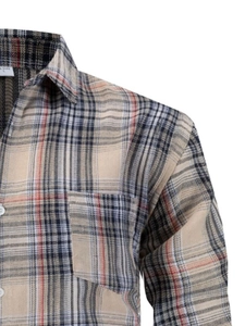 Detail of the collar and breast pocket on a beige plaid business casual shirt