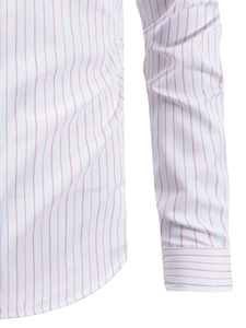 Close-up of orange vertical stripes and contrast cuff stitching on white men's shirt
