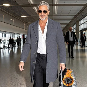 Men's grey business wool trench coat styled with suit trousers in airport terminal