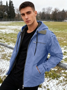 Men's blue hooded workwear jacket with warm lining and zipper in outdoor winter setting