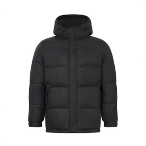 Detailed macro view of black hooded puffer jacket with windproof matte texture and zippers