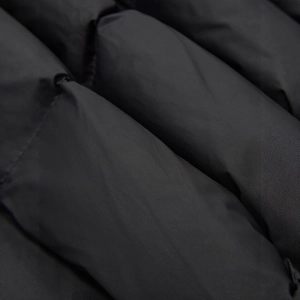 Detailed macro view of black quilted down jacket fabric with high-density windproof stitching
