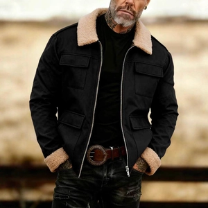 Detail of black workwear jacket featuring warm beige faux shearling collar and cuffs