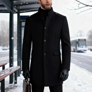 Mens slim fit black wool coat with stand collar and single breasted buttons in winter snow