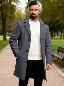 Men's single-breasted grey wool business coat with classic lapel in a stylish outdoor setting