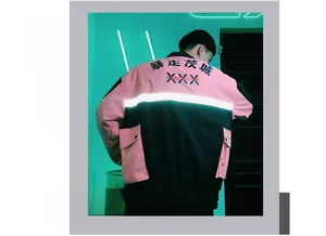Back view of a pink and black streetwear jacket featuring reflective strips and kanji print