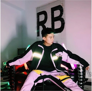Detail of color-block jacket with reflective strips and multi-pocket cargo pants