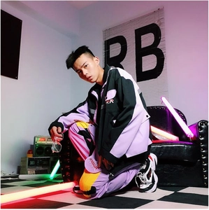 Detail of street-style windbreaker set featuring purple and black spliced patchwork fabric