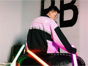 Detail of pink and black streetwear windbreaker with back graphic print and embroidery