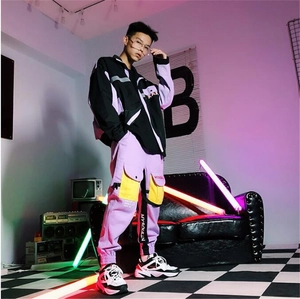 Detail of streetwear jacket and cargo pants with brand ribbon and neon cyberpunk lighting