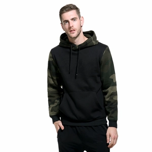 Detail of men's black hoodie with green camouflage sleeves and a front kangaroo pocket