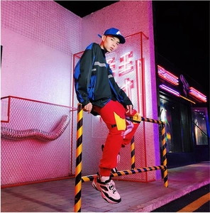 Streetwear men jacket close-up with reflective stripes and color-block stitching detail