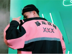 Detailed view of pink and black streetwear jacket featuring bold back letter printing