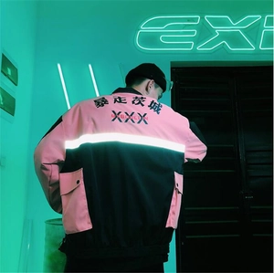 Rear detail of pink and black streetwear jacket featuring reflective strip and urban text