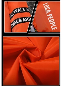 Detail der hellorangen Windjacke mit Webband von PERCIVAL & ARTHUR und weißem Druck