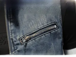 Detail shot of washed blue denim fabric texture and smooth metal zipper on motorcycle vest