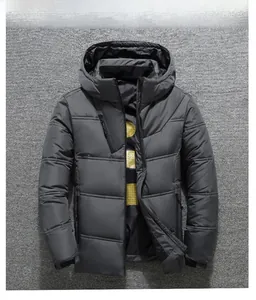 Detail of dark grey quilted puffer jacket featuring triple zipper pockets and yellow lining