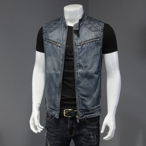 Close-up of deep blue washed denim vest showing quilted shoulder stitching and front zipper