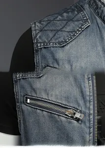 Detailed shot of dark blue denim vest featuring diamond quilted stitching and zipper pocket