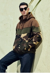 Macro view of men's camouflage hoodie with color block design and adjustable drawstrings