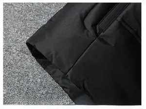 Macro shot of quilted down jacket hem with hidden zipper pocket and precise stitching