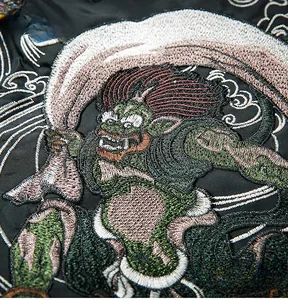 Detailed macro shot of high-density Yokosuka embroidery on cotton bomber jacket