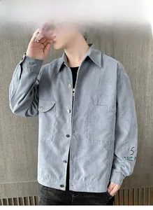 Close-up of grey corduroy jacket featuring lapel collar and numeric embroidery on sleeve