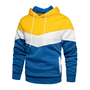 Detail of color-block hoodie featuring yellow, white, and blue V-shaped panel design