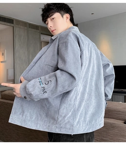 Detailed view of light gray corduroy jacket sleeve with TAKE FIVE text embroidery