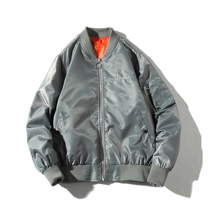 Detail of grey bomber jacket showing airclub embroidery and orange lining contrast