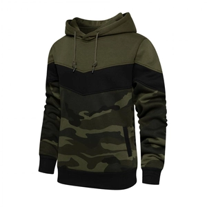 Detailed close-up of hooded sweatshirt with army green, black, and camo patchwork design