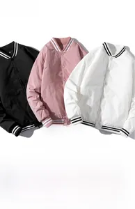 Detail of ribbed collar and snap buttons on black, pink, and white baseball jackets