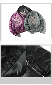 Detailed close-up of eagle embroidery and metal zipper on bomber jacket back