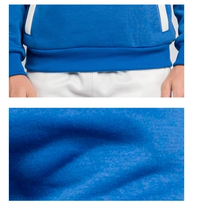 Detail view of blue knit hoodie showing elastic ribbed hem and white-lined pocket texture
