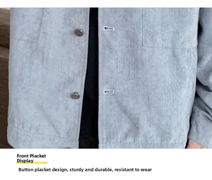 Macro detail of light blue corduroy jacket showing button placket and pocket stitching