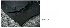Detail of elastic ribbed hem on black MA-1 bomber jacket with metal zipper part