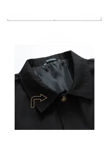 Detail view of the classic black collar and premium fabric texture of the men's trench coat
