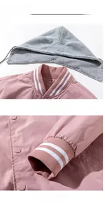 Detail of pink baseball jacket featuring a detachable grey hood and striped rib collar