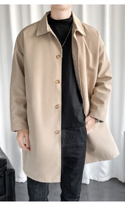 Detail of light khaki trench coat with amber buttons and classic notched lapel design