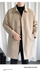 Detail of a khaki men's trench coat featuring classic lapels and amber buttons in a slim fit