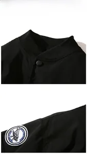 Close-up of MA1 bomber jacket featuring embroidered sleeve patch and ribbed collar