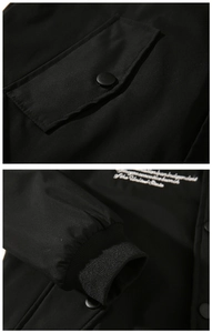 Close-up of MA1 bomber jacket with detailed embroidery, snap pocket and ribbed cuff
