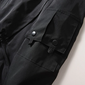 Detail of MA1 bomber jacket featuring a tactical black pocket with dual snap closures