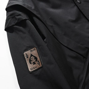 MA1 bomber jacket detail featuring black spade ace embroidery with skull on sleeve